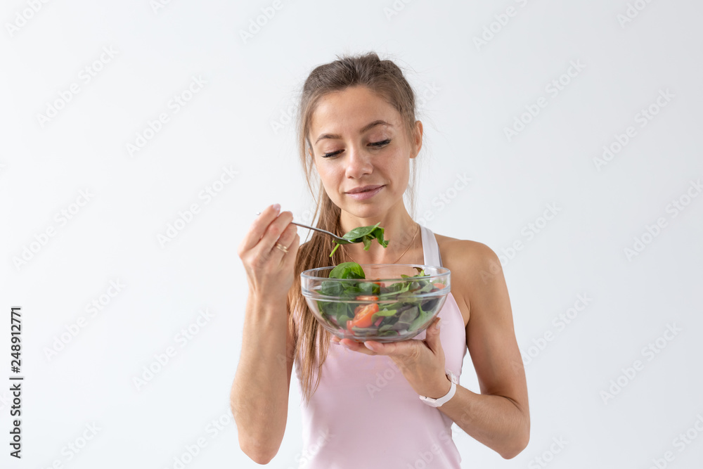 People, food and diet concept - Portrait of woman eating healthy food over white background People, food and diet concept - Portrait of woman eating healthy food over white background