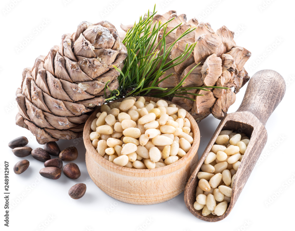 Pine nut cone and pine nuts on the white background. Organic food. Pine nut cone and pine nuts on the white background. Organic food.