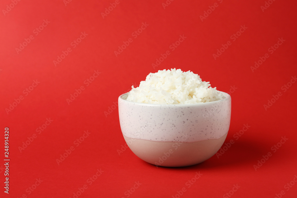 Bowl of boiled rice on color background. Space for text Bowl of boiled rice on color background. Space for text