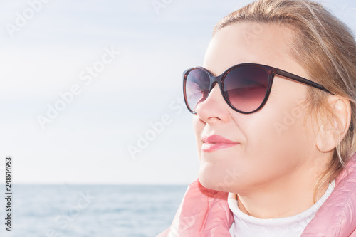 portrait of middle-aged woman outdoors against the sea