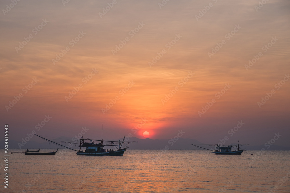 Thai fishing boat at sea during sunset