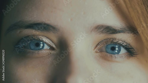 part of young woman face, blue eyes blinking, blur out of focus, pupil reaction to light, natural beauty concept,health, medicine and genes