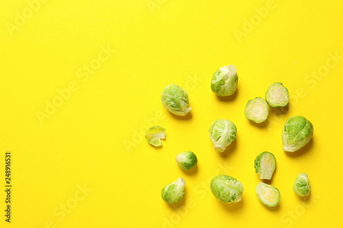 Fresh Brussels sprouts on color background, flat lay. Space for text
