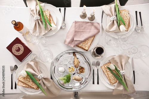 Festive Passover table setting with Torah, top view. Pesach celebration photo