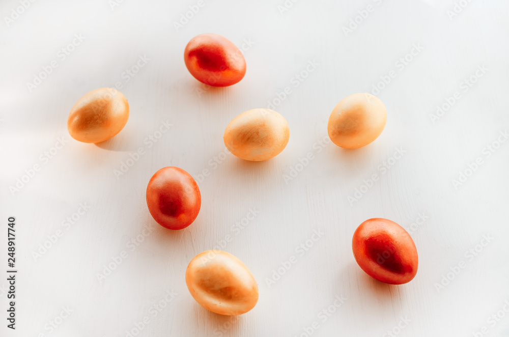 Multi-colored eggs on a white background. Creative Easter concept. Living coral - the color of the year 2019