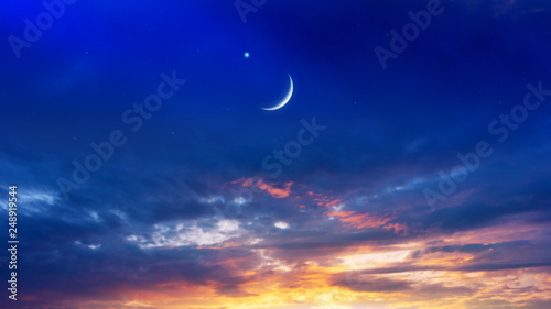 Crescent moon with beautiful sunset background . Generous Ramadan . Light from sky . Religion background .  