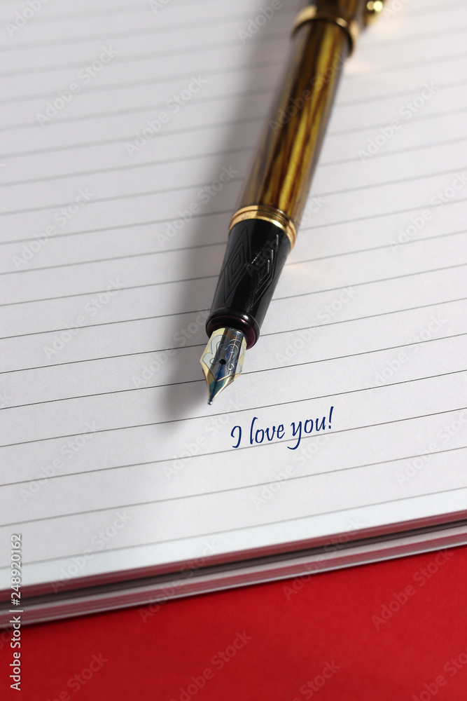 Fountain pen and notebook on table Fountain pen and notebook on table