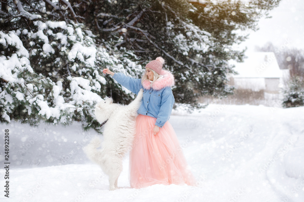 beautiful girl with a dog on a walk in the winter forest. beautiful girl and her pet. beautiful girl with a dog on a walk in the winter forest. beautiful girl and her pet.