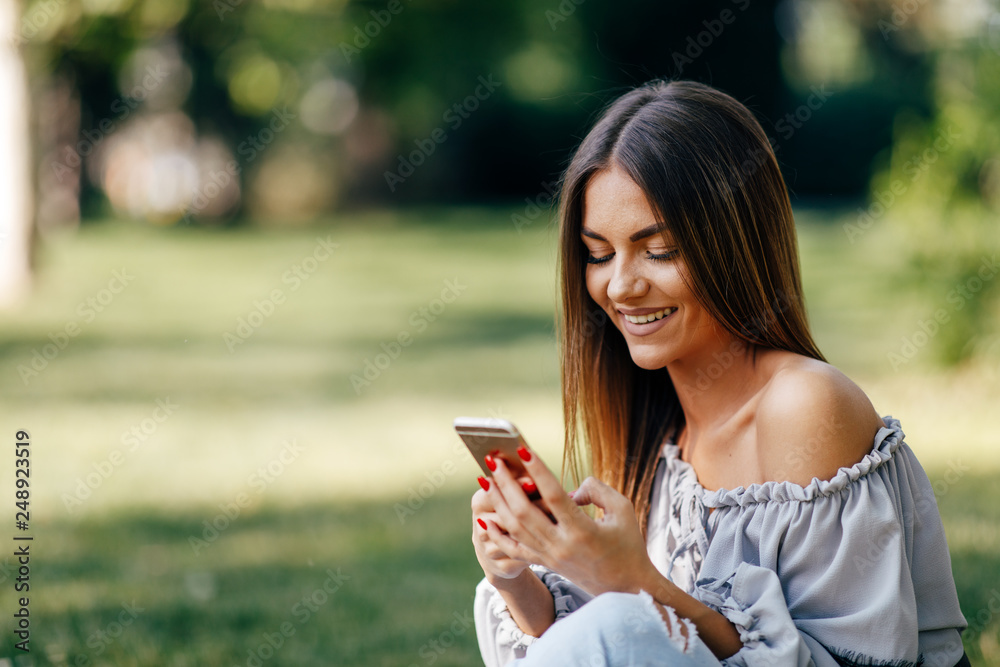 Young woman using a smartphone in the park