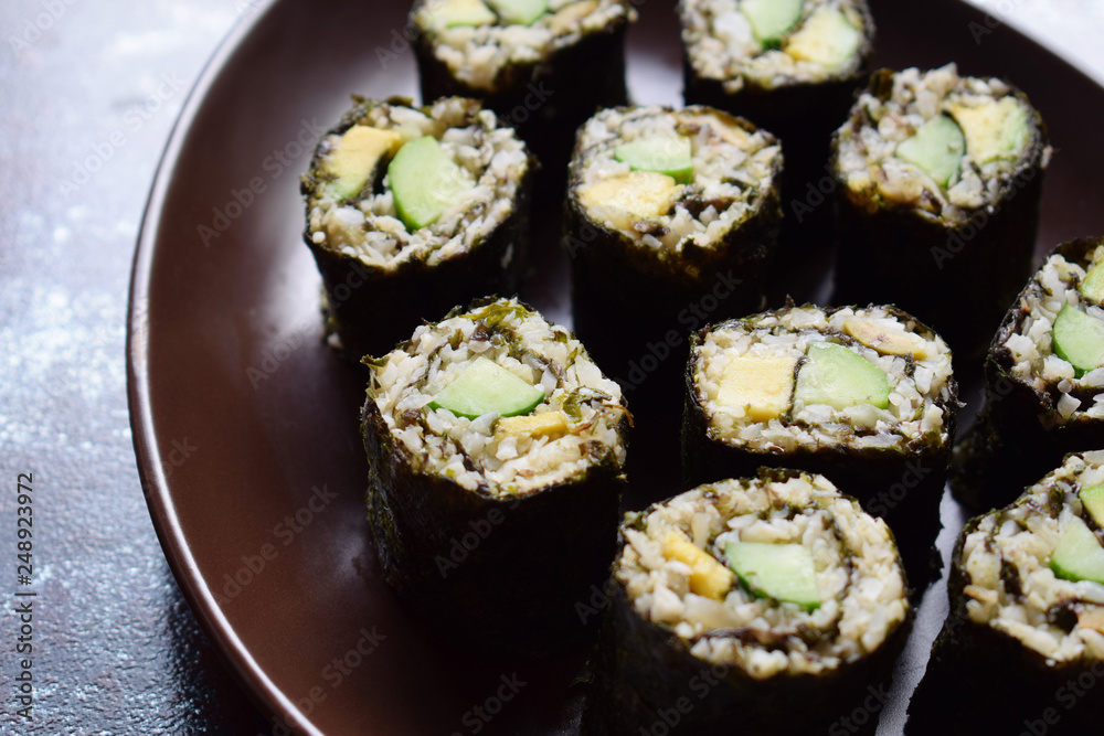 Sushi from cauliflower, avocado and tuna. Traditional Asian food. Diet healthy food concept. Cereal free. Gluten free. Dairy free. AIP Autoimmune Paleo. Sushi from cauliflower, avocado and tuna. Traditional Asian food. Diet healthy food concept. Cereal free. Gluten free. Dairy free. AIP Autoimmune Paleo.