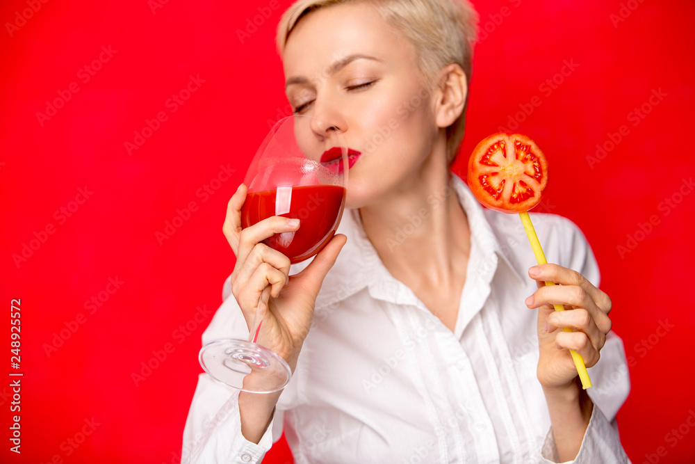 woman with a glass of red tomato juice. Healthy lifestyle concept woman with a glass of red tomato juice. Healthy lifestyle concept