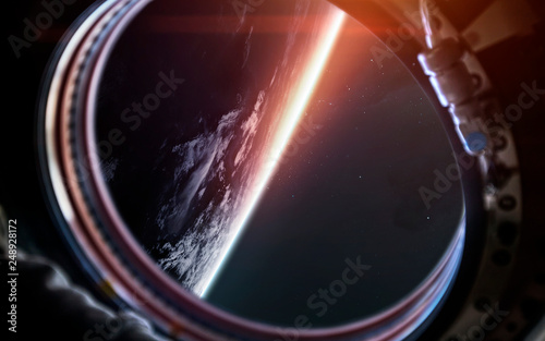 Fototapeta Naklejka Na Ścianę i Meble -  Earth planet from the spaceship porthole. Science fiction art. Elements of this image furnished by NASA