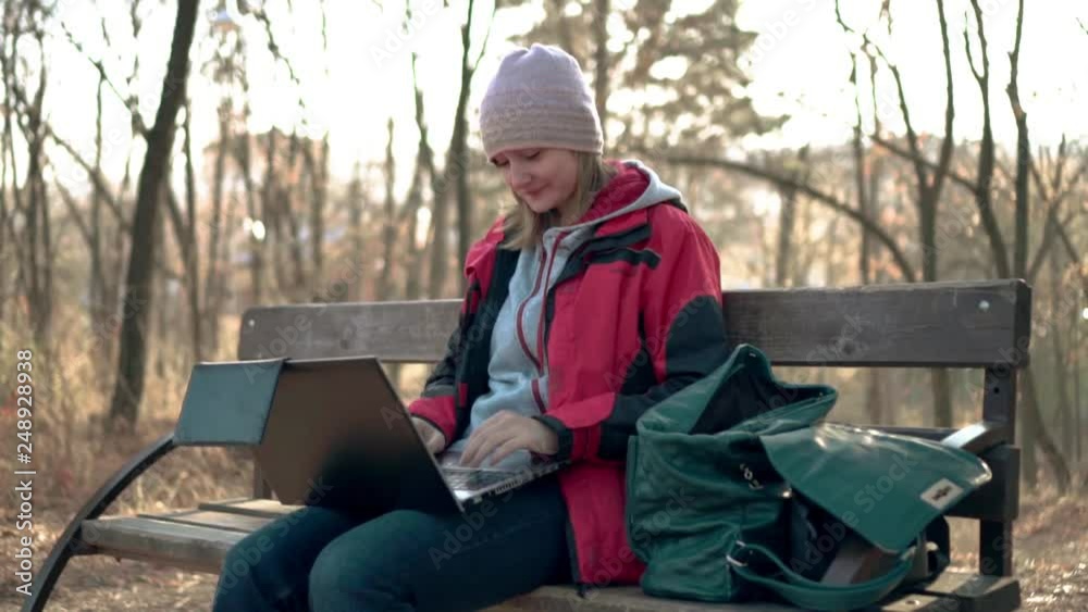 girl in the Park operates on a laptop