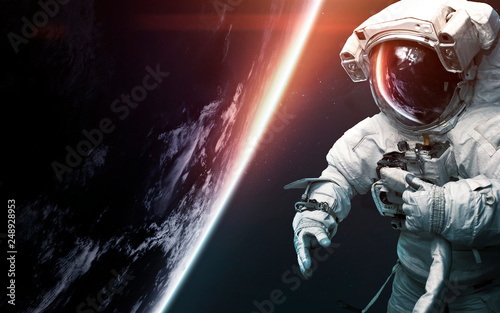 Fototapeta Naklejka Na Ścianę i Meble -  Astronaut at spacewalk. Science fiction art. Elements of this image furnished by NASA