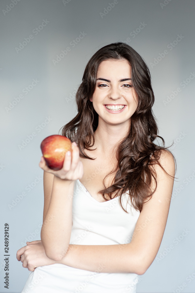 smiling woman holding red apple. studio isolated portrait. smiling woman holding red apple. studio isolated portrait.