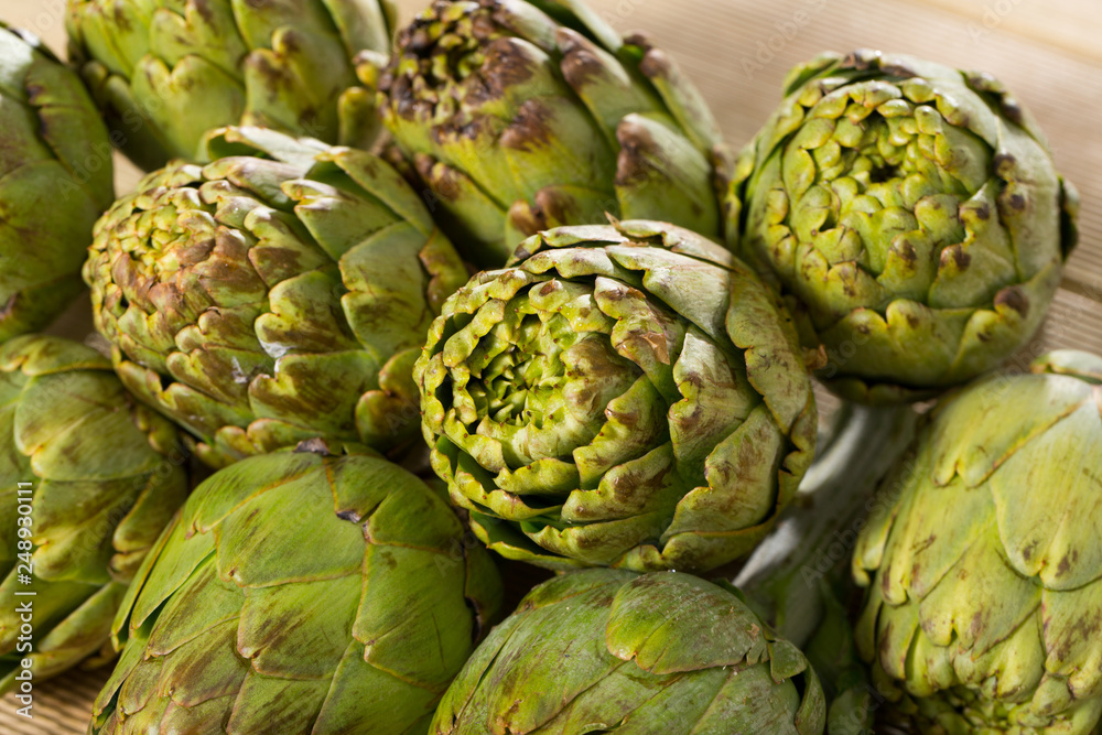 Fototapeta premium Artichokes on wooden table
