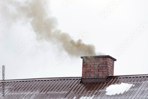 Smoke coming out of the house chimney