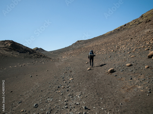 Backpacker on volcanic lava sand. Perfect destination for hikers. The Legendary Laugavegur Trek, Iceland.