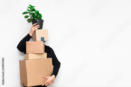 Man with box moving in a new apartament. Moving concept. photo
