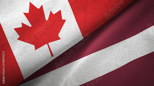 Canada and Latvia two flags textile cloth, fabric texture