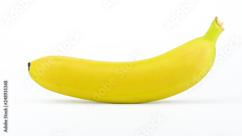 One ripe yellow banana isolated on a white background.