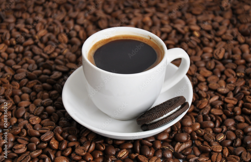 cup of coffee and cookie with beans background cup of coffee and cookie with beans background