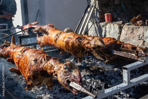 Whole lambs baked on a spit, direct on fire outdoor