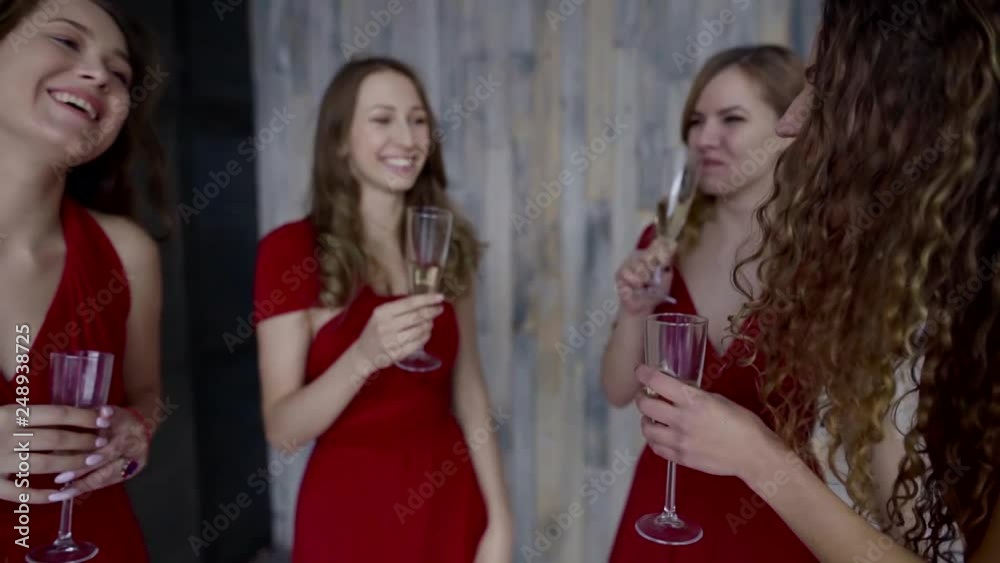 Four girl in same red dresses having fun at bachelorette party. Four girl in same red dresses having fun at bachelorette party.