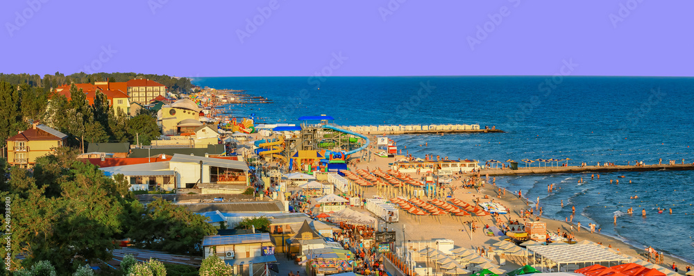 Fototapeta premium Iron Port (Zaliznyi Port), Kherson Oblast, Ukraine - july 2018: a large crowd of people on the Black Sea coast. A huge beach in the Iron Port.