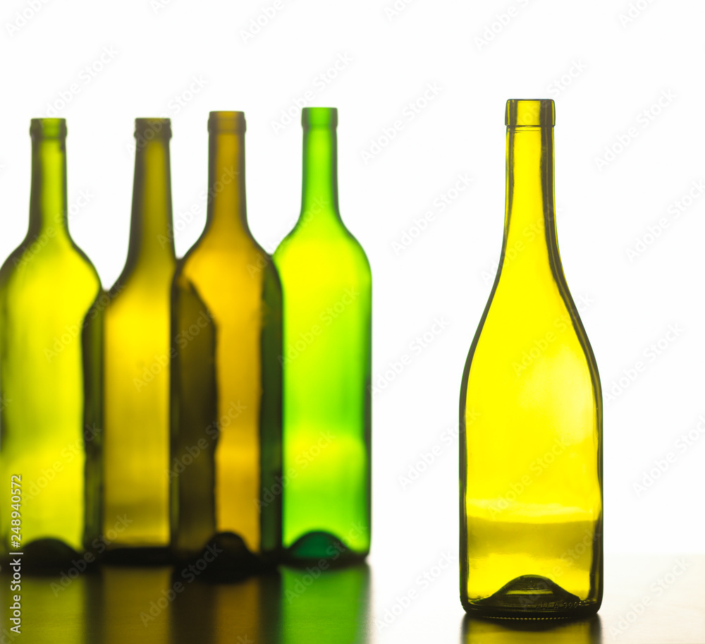 GROUP OF FIVE GREEN AND BROWN WINE BOTTLES ON WHITE BACKGROUND GROUP OF FIVE GREEN AND BROWN WINE BOTTLES ON WHITE BACKGROUND