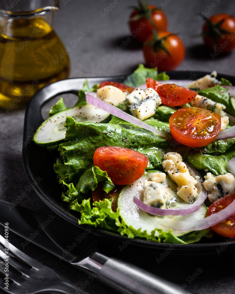 Fresh green salad with blue cheese, onions and cherry tomatoes Fresh green salad with blue cheese, onions and cherry tomatoes