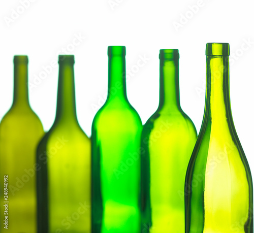 ABSTRACT IMAGE OF GROUP OF FIVE GREEN WINE BOTTLES ON WHITE BACKGROUND