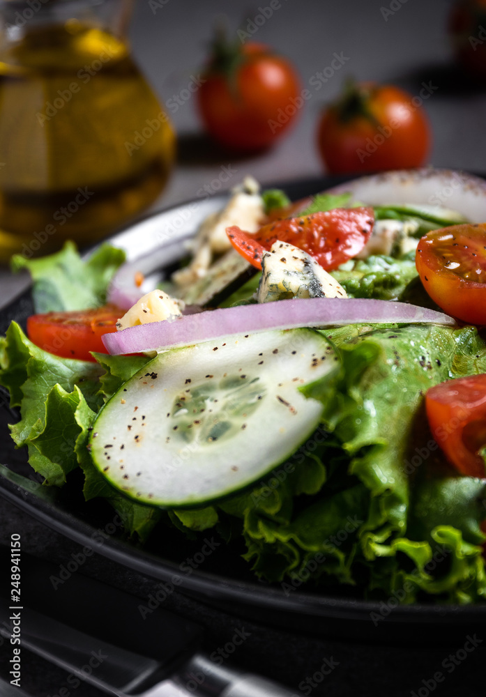 Fresh green salad with blue cheese, onions and cherry tomatoes Fresh green salad with blue cheese, onions and cherry tomatoes