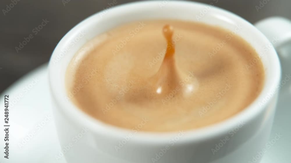 Drop falling into a cup of coffee in super slowmotion.