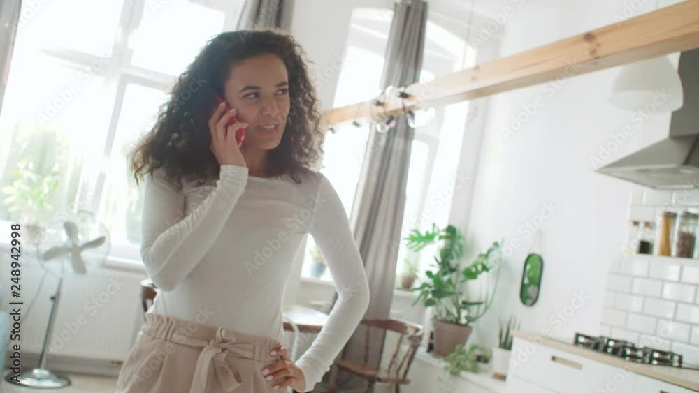 Charming young woman using phone at modern stylish apartment. Charming young woman using phone at modern stylish apartment.