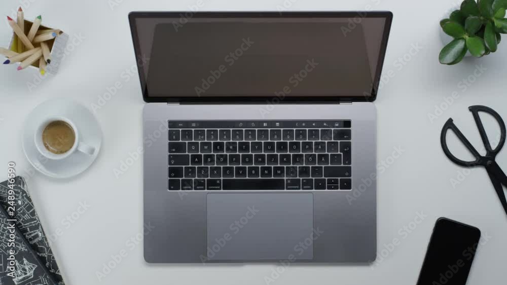 Male hands typing laptop on white clean minimalistic table with top view, gestures and finger movements Male hands typing laptop on white clean minimalistic table with top view, gestures and finger movements
