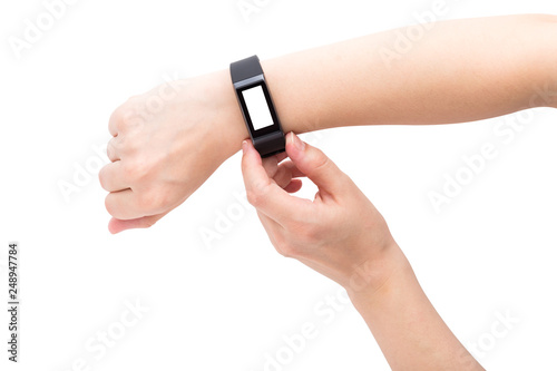 Fitness bracelet on a female hand. One hand clicks on the fitness tracker. Blank display.