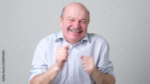 Funny senior man dancing on birthday party.