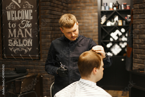 man in barbershop making a new hairdresser with barber 