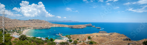 Panoramic view over local beach in an enclosed bay in Lindos village famous for an ancient Acropolis. Island of Rhodes. Greece. Europe.
