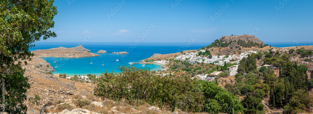 Panoramic view over Lindos village with ruins of ancient Acropolis. Island of Rhodes. Greece. Europe.