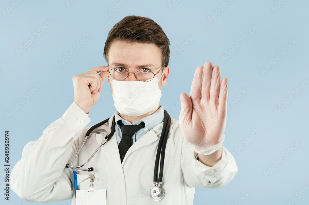 guy doctor shows with hand palm stop sign on a blue isolated background.Concept medicine and health