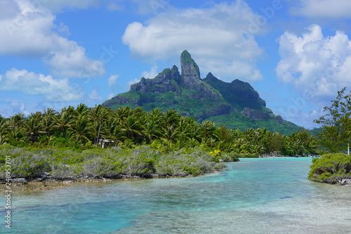 View of the Mont Otemanu mountain seen from the water over the reef between the ocean and the lagoon in Bora Bora, French Polynesia, South Pacific