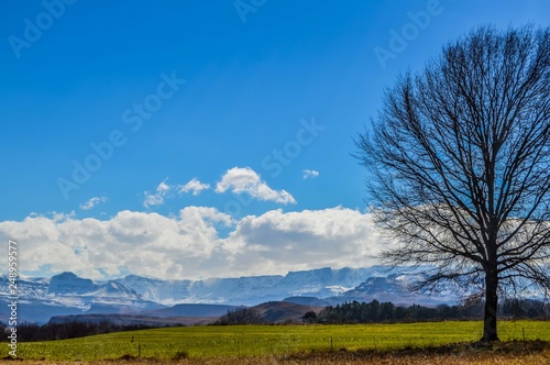 Snow landscape in Drakensberg mountains in Underberg South Africa under blue sky and flakey clouds