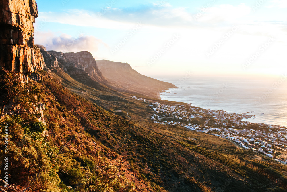 Stunning view of the dramatic landscape of the 12 apostles at sunset, seen from Kloof Corner lookout point on Table Mountain in Cape Town, South Africa