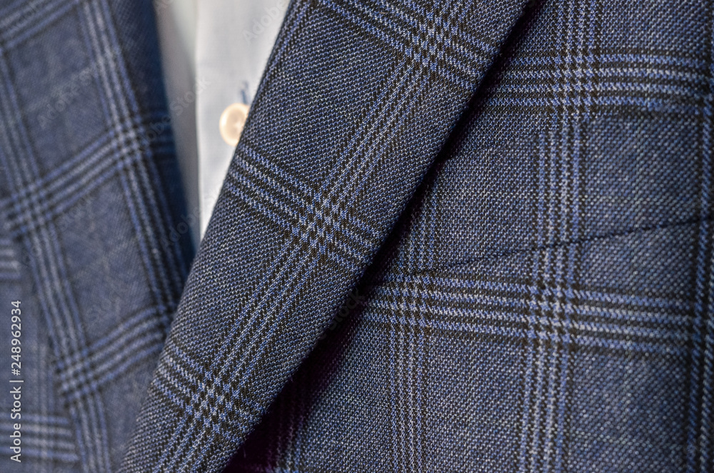 Close up of dark blue checked suit with lapels fragment