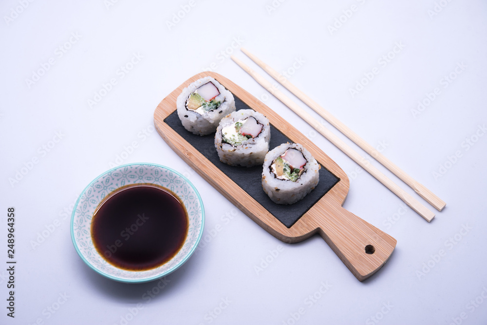 table with sushi and chopsticks with bowl of soy sauce table with sushi and chopsticks with bowl of soy sauce