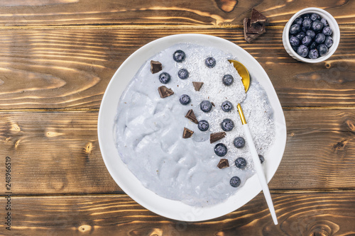 Top view of blue yogurt smoothie bowl made with blueberry