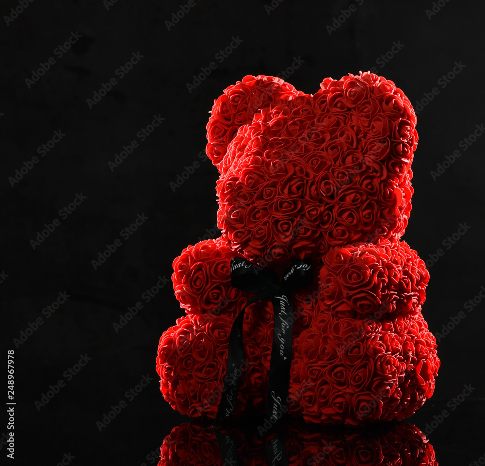 Red bear of roses present gift for valentines day or woman birthday on dark - obrazy, fototapety, plakaty 