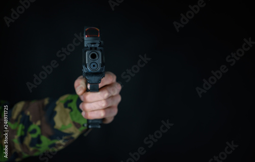 Soldier holds gun in the hand